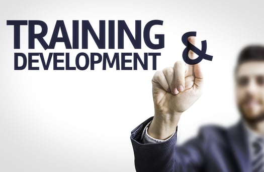 Business man pointing to transparent board with text Training & Development Business man pointing to transparent board with text Training & Development